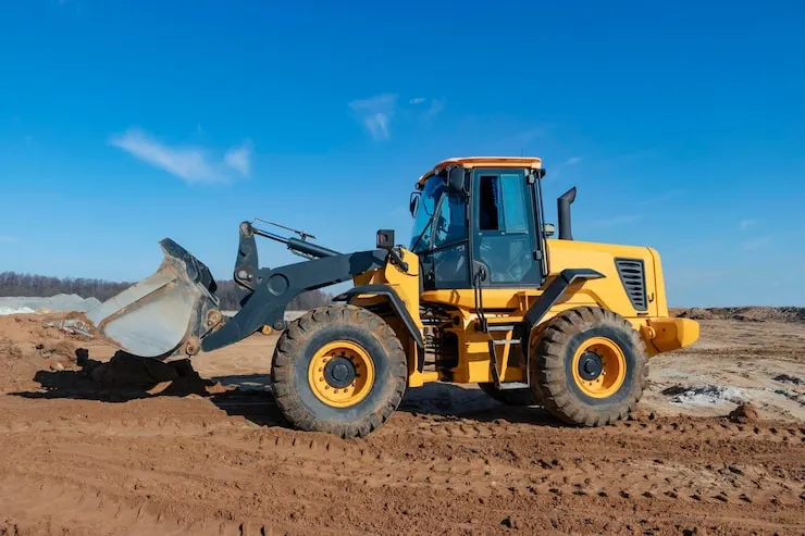 bulldozer-loader-moves-earth-construction-site-against-blue-sky-earthmoving-machine-is-leveling-site-construction-heavy-equipment-earthworks_331695-3841