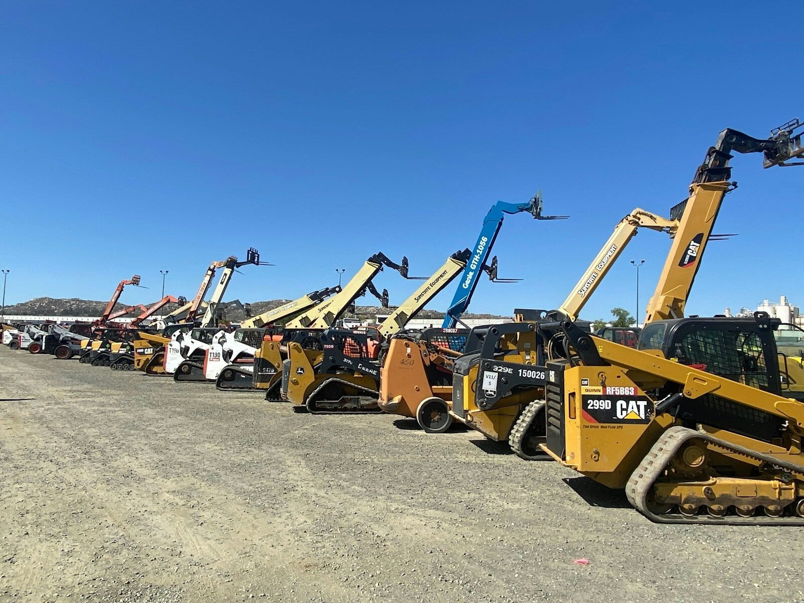 a group of yellow and black construction vehicles