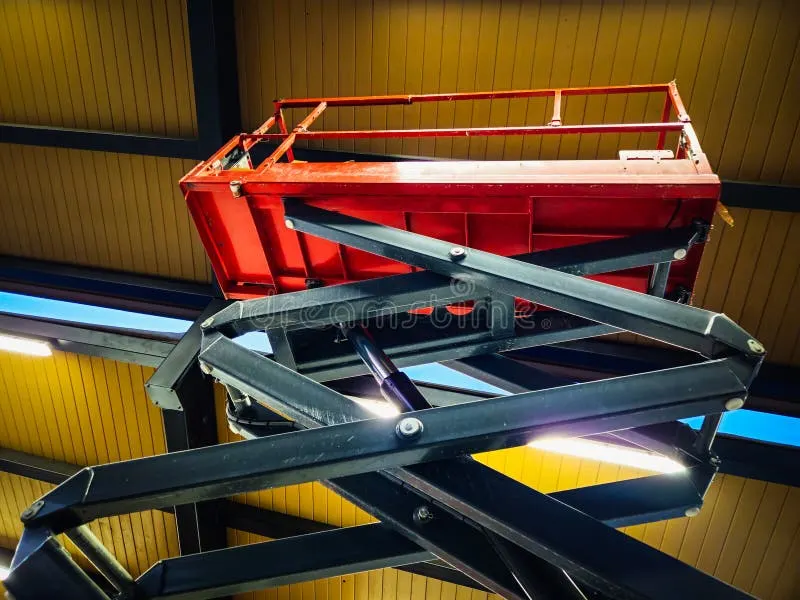 looking-up-view-scissor-lift-heavy-duty-construction-equipment-under-roof-397254059
