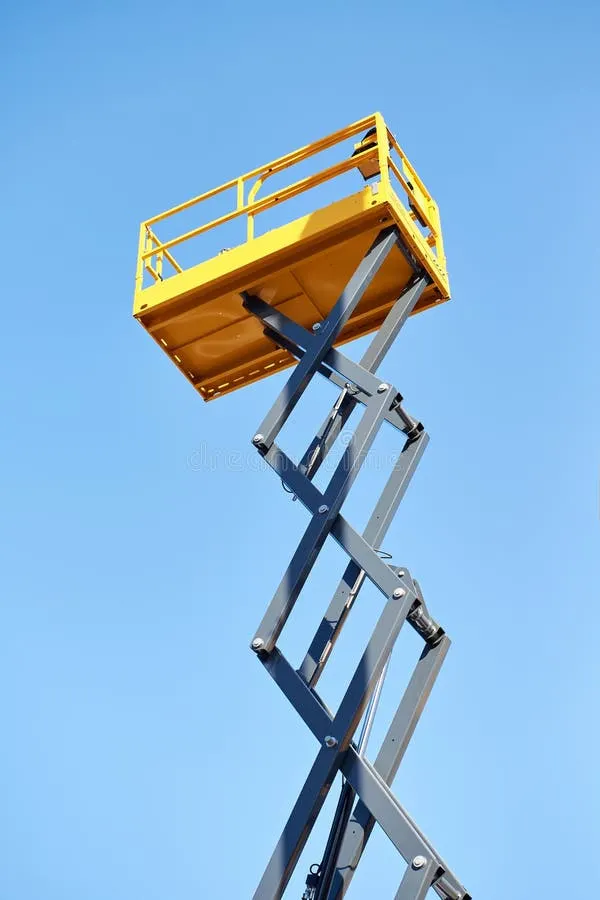 scissor-lift-platform-raised-high-against-clear-blue-sky-low-angle-view-yellow-extended-upward-industrial-lifting-equipment-451780044